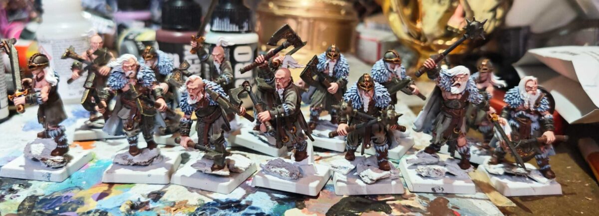 IMUnit of painted Norse raider miniatures used as Chaos Cultists, with pale fur, dark clothing and unfinished bases.G-20261015-WA0003 Unit of painted Norse raider miniatures used as Chaos Cultists, with pale fur, dark clothing and unfinished bases.